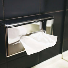 White facial tissues pulled from under-counter dispenser tray