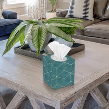 Facial tissue box with tissue protruding from opening, teal geometric sides