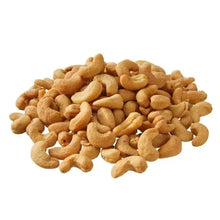 Whole unsalted cashews pile in natural tan color
