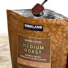 Kirkland Signature medium roast coffee bag close-up with scoop, arabica beans.