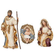 Nativity set figurines: Joseph with staff, Mary holding baby, and manger