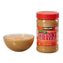 Kirkland Signature organic creamy peanut butter jar with bowl of peanut spread