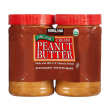 Kirkland Signature organic creamy peanut butter jars, two with red caps