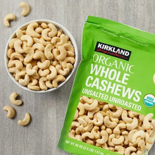 Organic whole cashews bag beside bowl of whole cashews