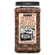 Kirkland peanut butter filled pretzel nuggets jar with label and brown nuggets