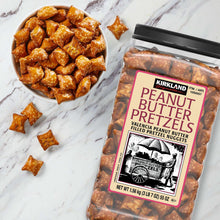 Peanut butter filled pretzel nuggets in bowl, golden-brown with white specks