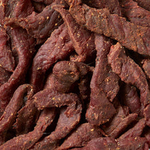 Close-up of extra thick cured steak strips with reddish-brown seasoning