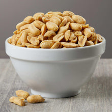 Roasted salted peanuts in a white bowl, extra-large golden kernels