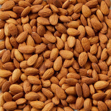 Whole almonds close-up of golden brown nuts piled together