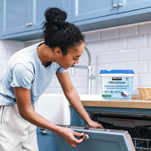 Kirkland Signature UltraShine detergent pac tub beside an open dishwasher