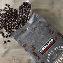 Kirkland Signature whole bean coffee bag corner with dark coffee beans scattered