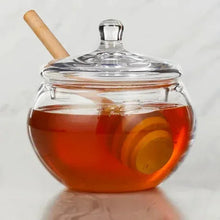 Wildflower honey jar with clear lid, amber honey and wooden spoon