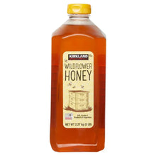 Kirkland Signature wildflower honey bottle, 5 lb, amber liquid, yellow cap