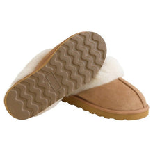 Shearling slipper pair showing the tan wavy-tread sole and suede upper
