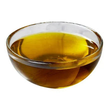 Glass bowl filled with golden extra virgin olive oil