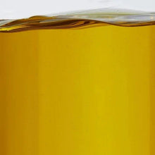 Golden olive oil close-up in the bottle, filling to near the top