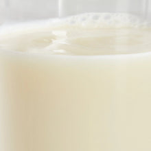 Off-white almond beverage surface in a container