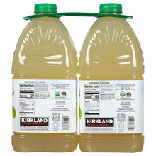 Two organic lemonade bottles with green caps, pale yellow liquid