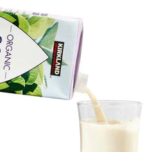 Organic soy beverage carton corner with soy drink in clear glass