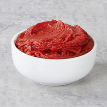 White bowl filled with red organic tomato paste