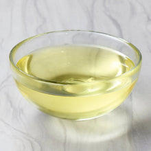 Glass bowl filled with golden vegetable oil