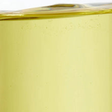 Clear vegetable oil bottle close-up with golden liquid filling the container