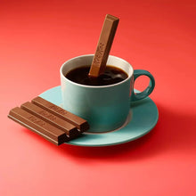 Chocolate wafer bar pieces with a chocolate bar stick in a mug of cocoa