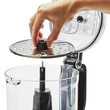 KitchenAid food processor with open lid and blade insert on black spindle