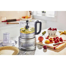 KitchenAid 7-cup food processor with clear bowl and sliced ingredients on counter