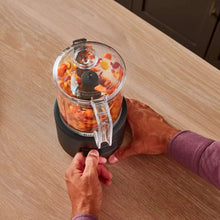 Cordless food chopper with open clear lid and diced food inside clear bowl