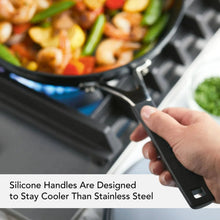 Black skillet with ergonomic silicone handle for comfortable grip