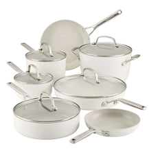 White nonstick pots and pans set with matching lids and curved metal handles