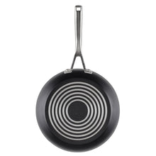 Black nonstick fry pan bottom with stainless handle and circular heat pattern