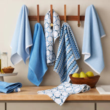 Blue kitchen towels hanging and folded, showing speckled and check patterns