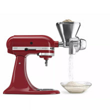 KitchenAid grain mill attachment with red stand mixer and metal hopper