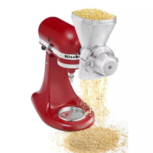 Grain mill attachment pouring yellow cornmeal from metal hopper