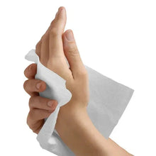 White 1-ply paper towel sheet held by hands for wiping surface