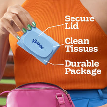 Kleenex Snap & Go tissues case held in hand, blue with secure lid