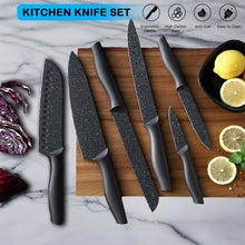 Assorted kitchen knives with black granite-style blades and ergonomic handles in a set