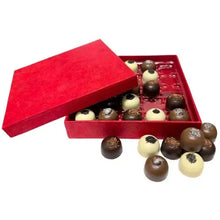 Caramel chocolate gift box with red lid and dark and cream truffles