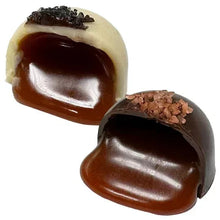 Heart-shaped chocolate truffles with dark and cream layers and crushed topping