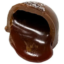 Heart-shaped chocolate truffle with glossy dark-brown coating and textured top