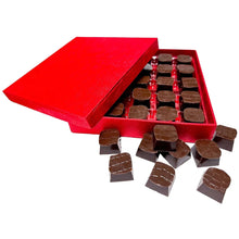 Open red gift box with dark chocolate truffle pieces