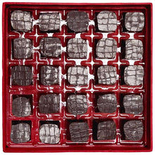 Box of dark chocolate truffles with individual wrapped pieces in a tray