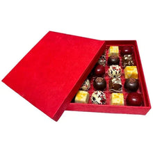 Chocolate gift box with red lid and open tray of assorted truffles