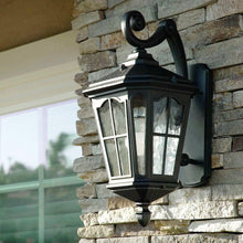 Outdoor wall lantern with curved arm and top canopy, clear glass panels, black