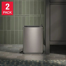 Stainless step trash can with pedal and hinged lid, closed on a bathroom floor.