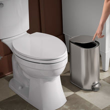 Stainless steel step trash can with raised lid and empty interior