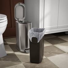 Stainless steel step trash can with open lid and gray liner bag
