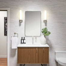 Wall-mounted rectangular mirror with rounded corners and silver metal frame